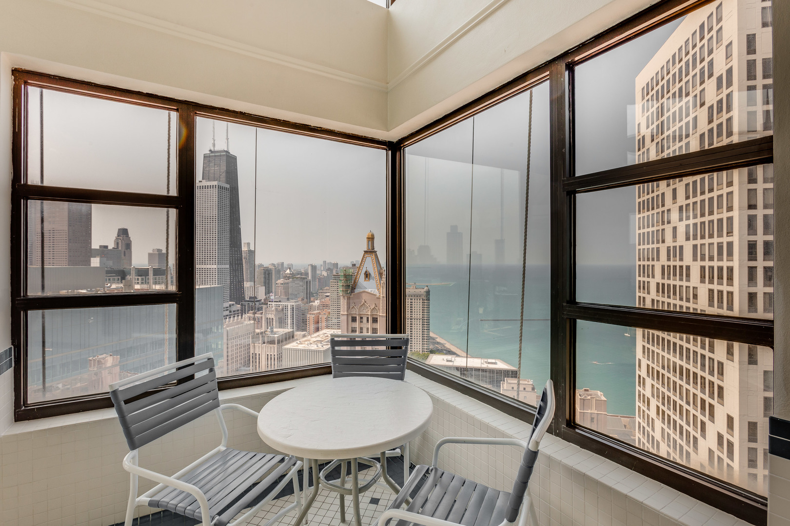 401 East Ontario Street, Unit 710 Chicago, IL 60611 - Photo 33 of 36 a dining room with furniture and a floor to ceiling window