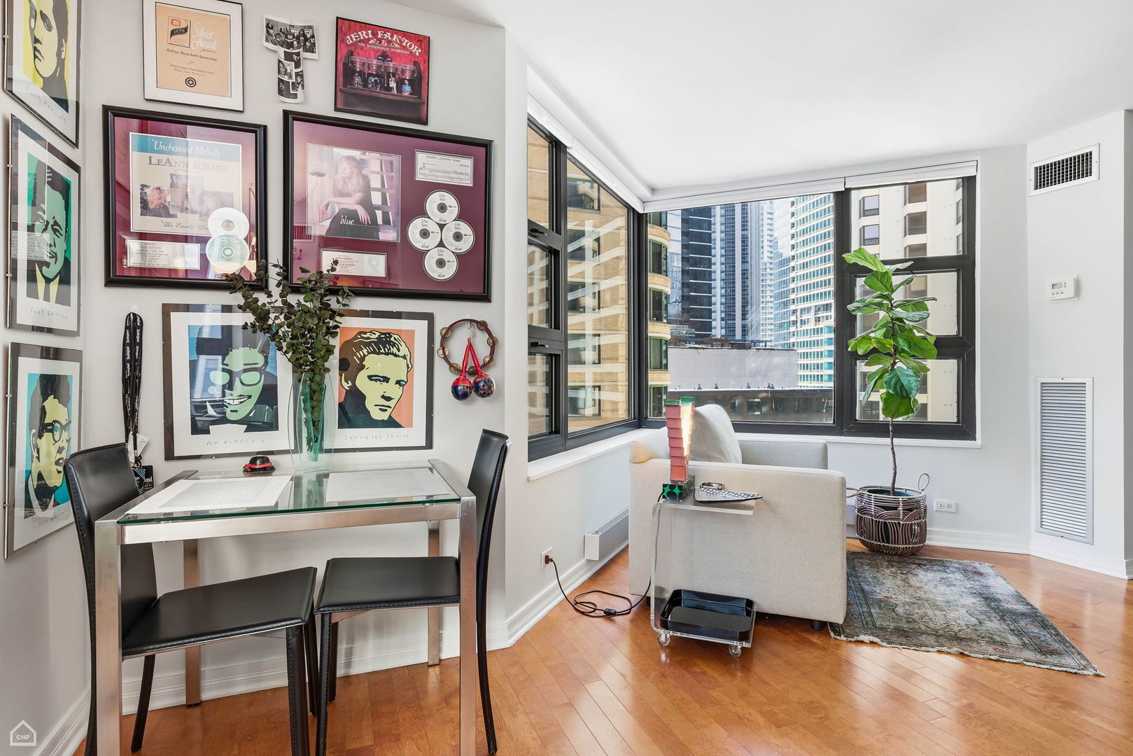 401 East Ontario Street, Unit 710 Chicago, IL 60611 - Photo 5 of 36 a living room with furniture wooden floor and wall paintings