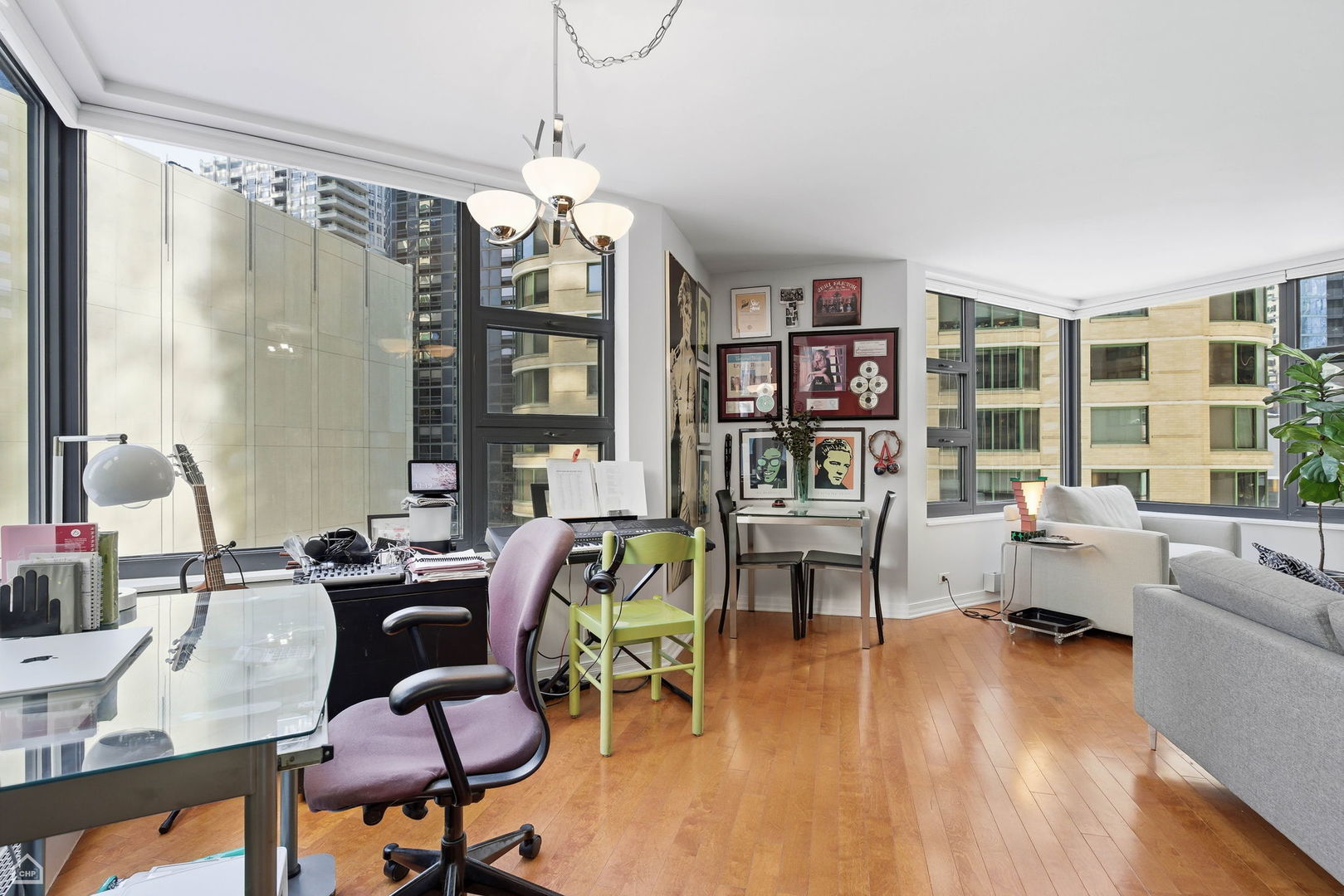 401 East Ontario Street, Unit 710 Chicago, IL 60611 - Photo 7 of 36 a living room with furniture and a chandelier