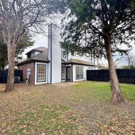 a house that has a tree in front of a house