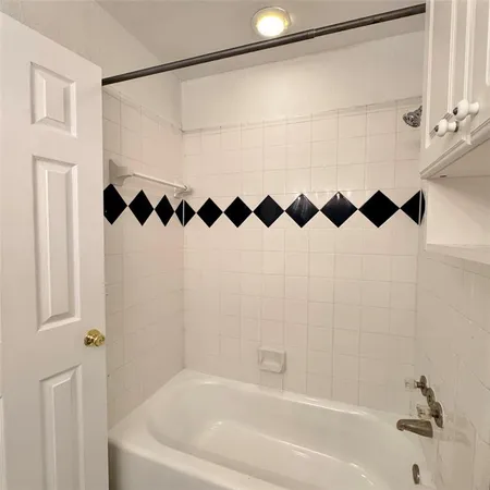 a bathroom with a bathtub and shower