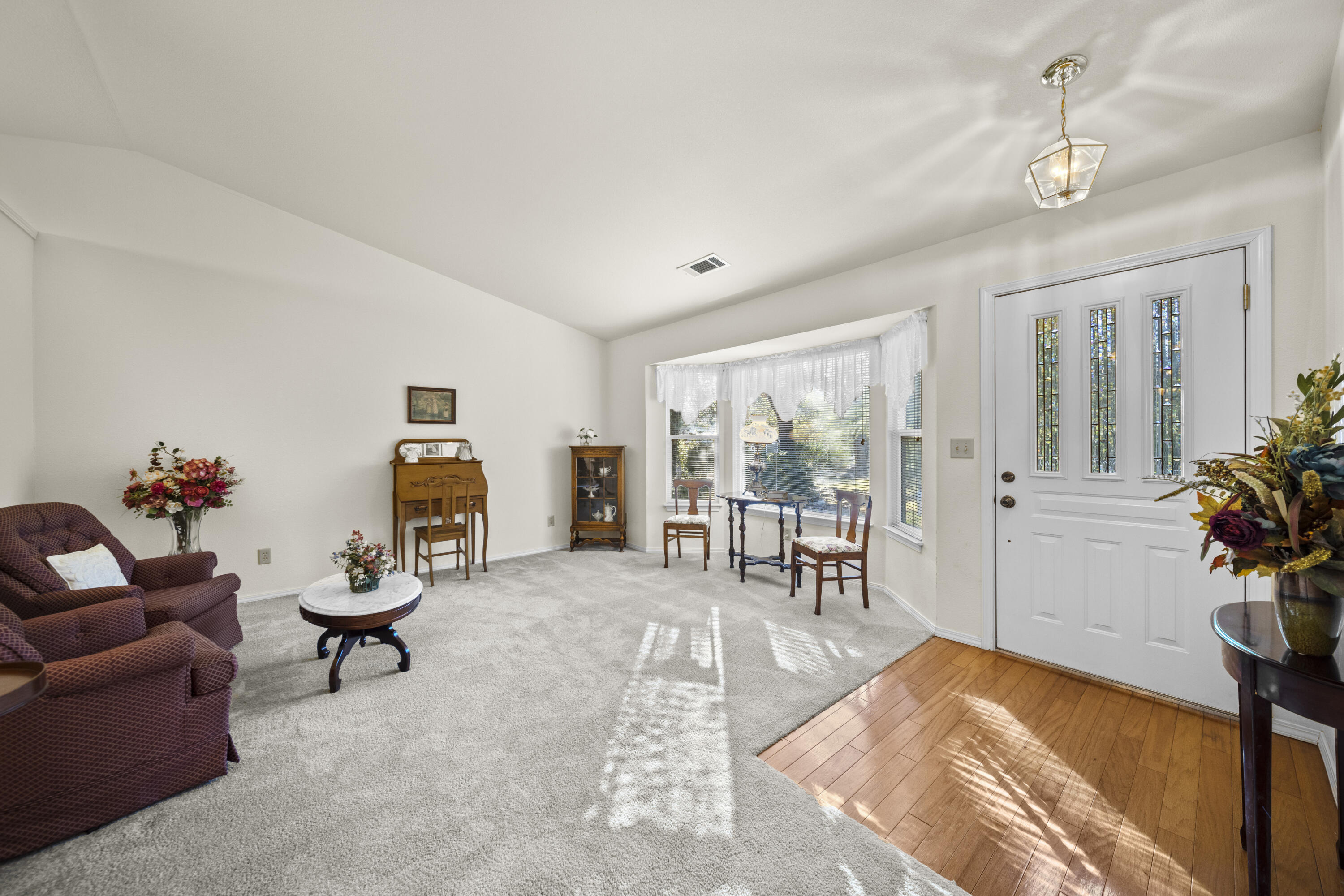 11627 Nash Road Redding, CA 96003 - Photo 3 of 41 a living room with furniture a dining table with wooden floor and potted plants