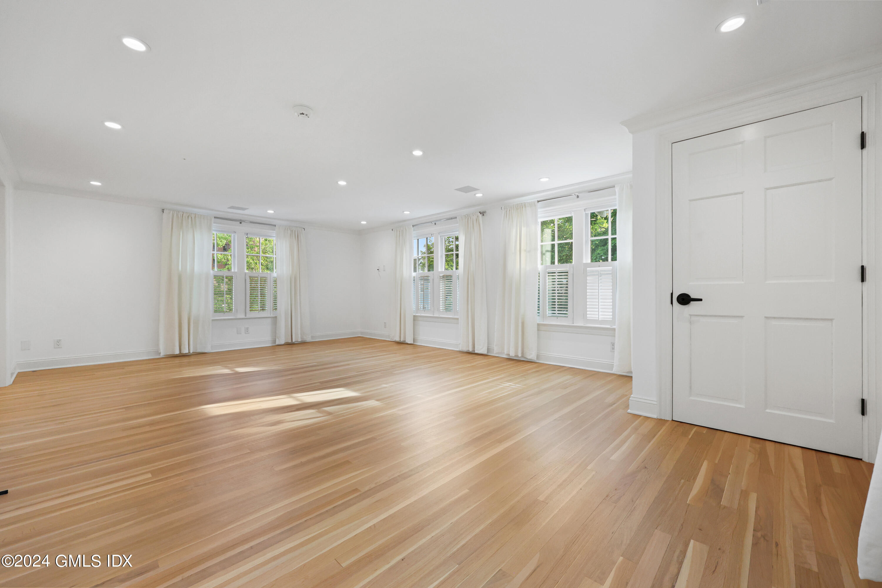 6 Benedict Place Greenwich, CT 06830 - Photo 13 of 16 an empty room with wooden floor and windows