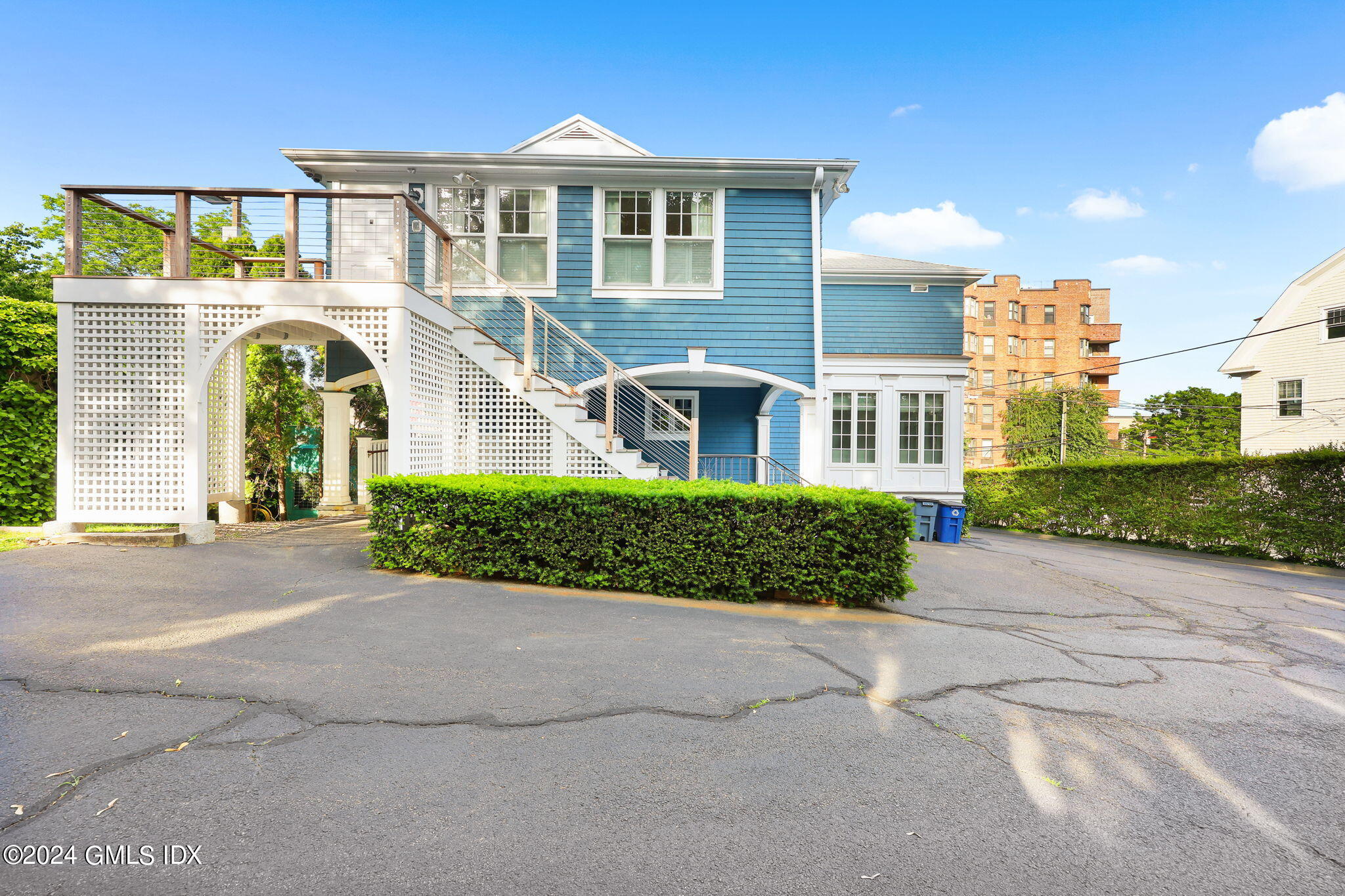 6 Benedict Place Greenwich, CT 06830 - Photo 2 of 16 a front view of a house with a garden