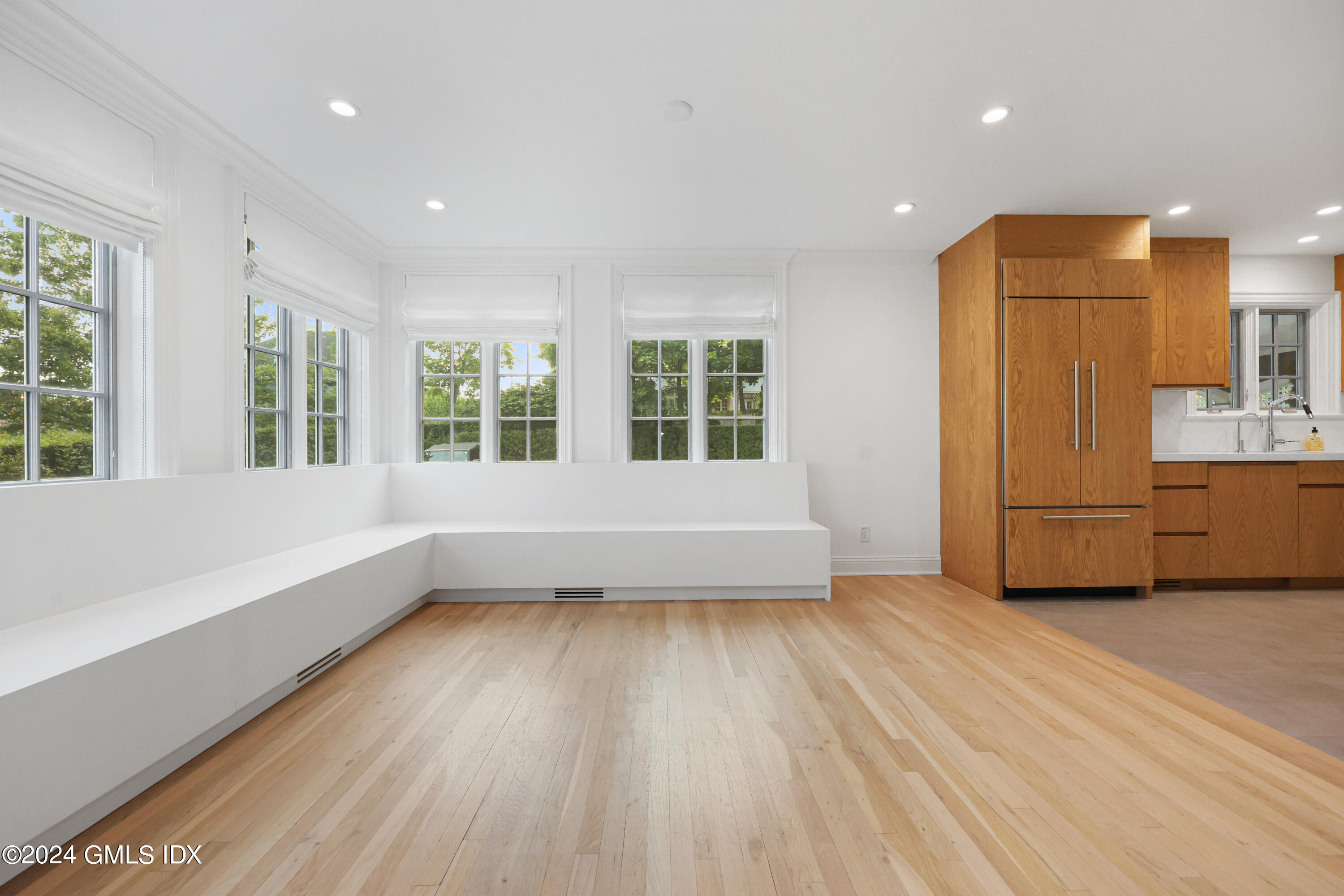 6 Benedict Place Greenwich, CT 06830 - Photo 7 of 16 an empty room with wooden floor and windows
