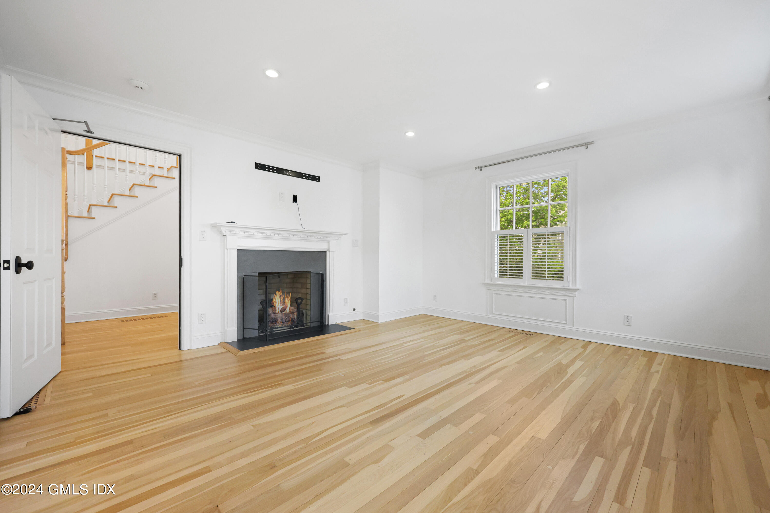 6 Benedict Place Greenwich, CT 06830 - Photo 8 of 16 a view of an empty room with wooden floor and a window
