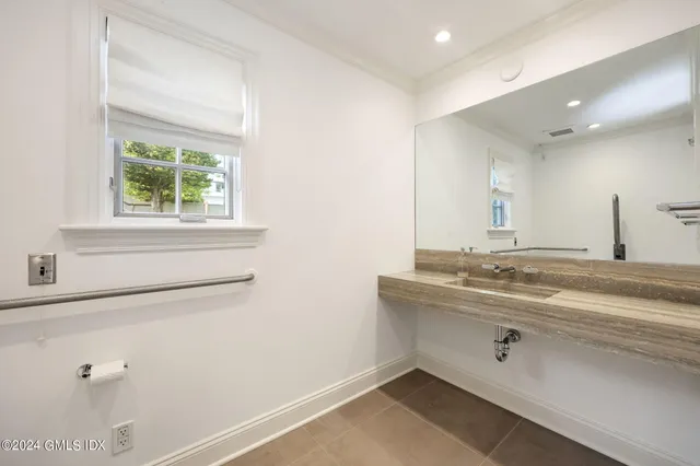 a bathroom with a sink and a window