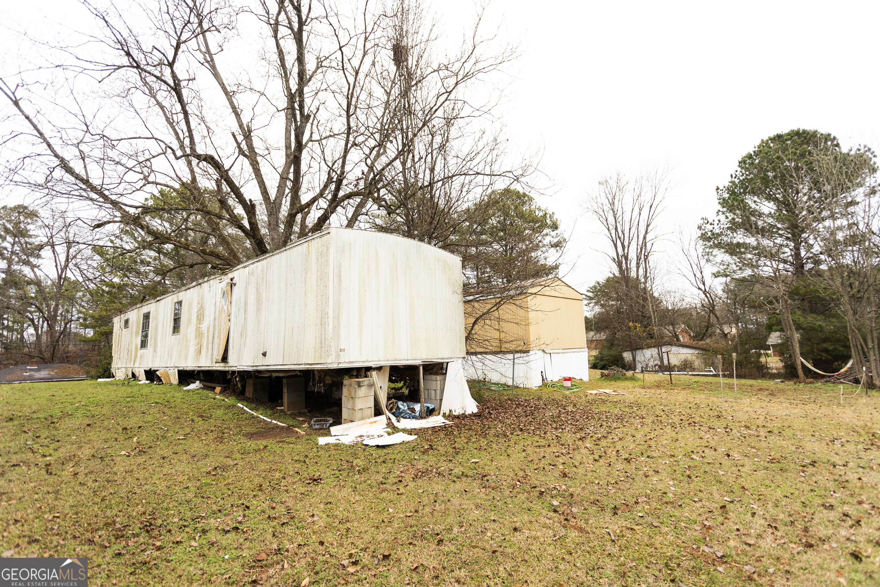 20 East Dollar Circle Covington, GA 30014 - Photo 25 of 31 a large white house with a yard covered in snow