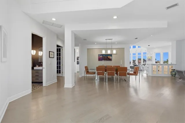 a living room with furniture and a view of kitchen