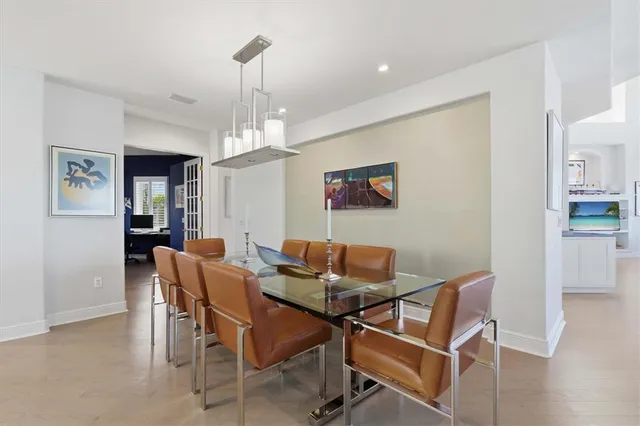 a living room with fireplace furniture and a kitchen view