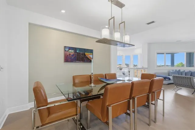 a living room with furniture a fireplace and a large window