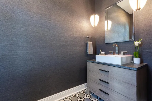 a view of a swimming pool with a lounge chair and floor to ceiling window