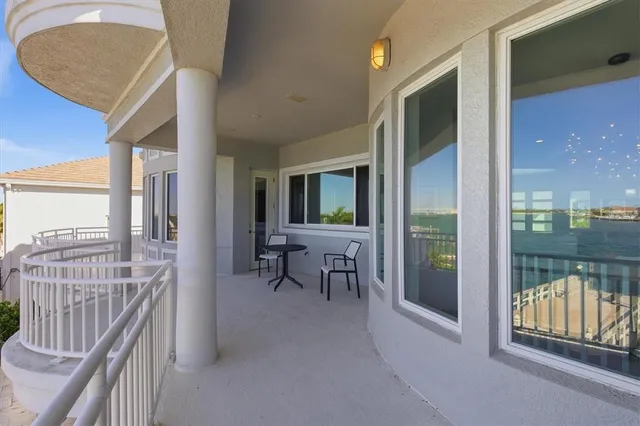 a aerial view of a house with swimming pool lake and mountain view
