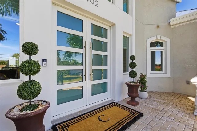 a view of a hallway with wooden floor and a bathroom