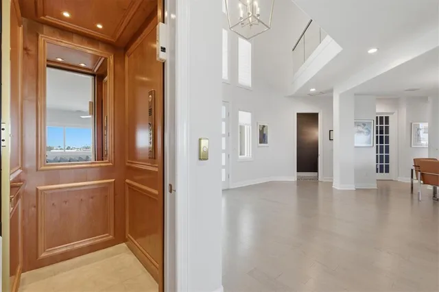 a living room with furniture and a view of kitchen
