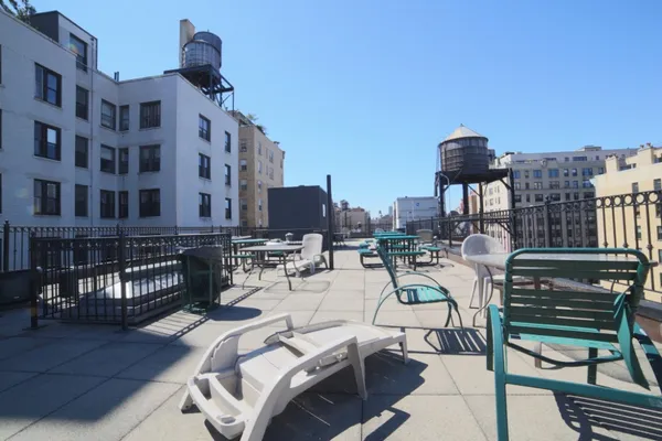 a view of a patio with chairs and potted plants