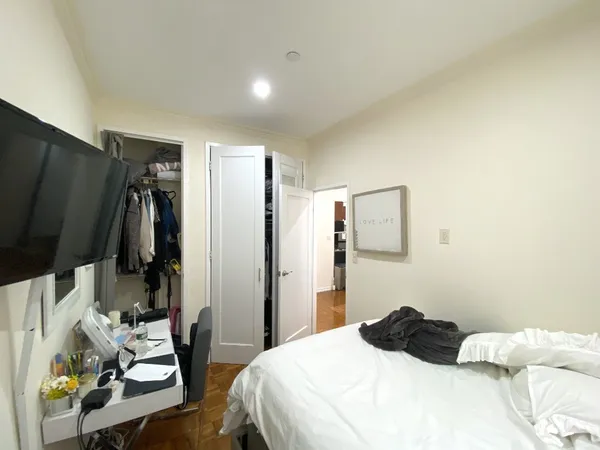 a bedroom with a bed and a couch