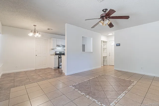 a view of a livingroom with a ceiling fan and window