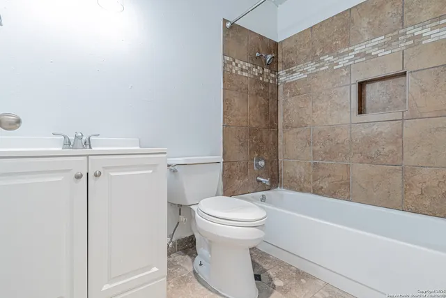 a bathroom with a toilet and a bathtub