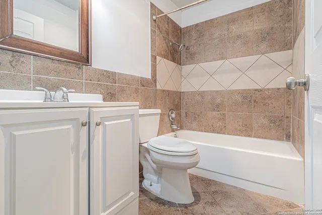 a bathroom with a sink a toilet and bathtub