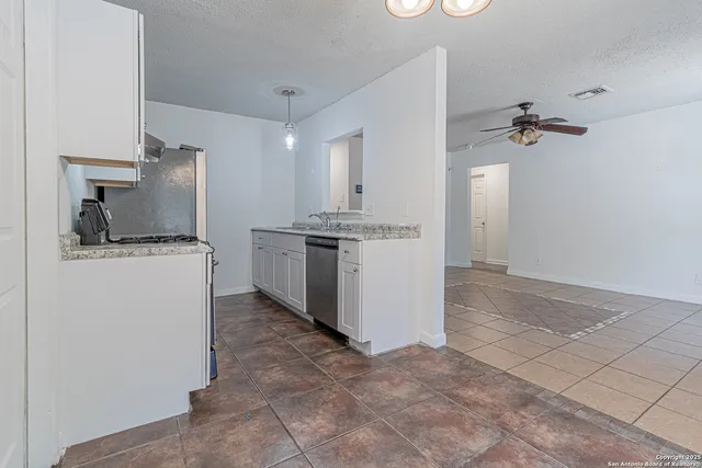 a kitchen with a stove a refrigerator and a sink