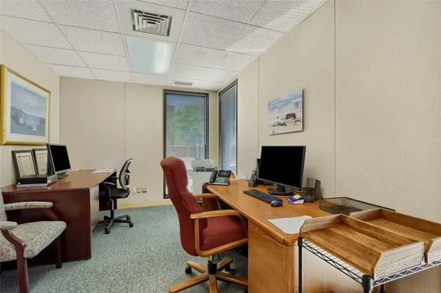 a view of a workspace with furniture