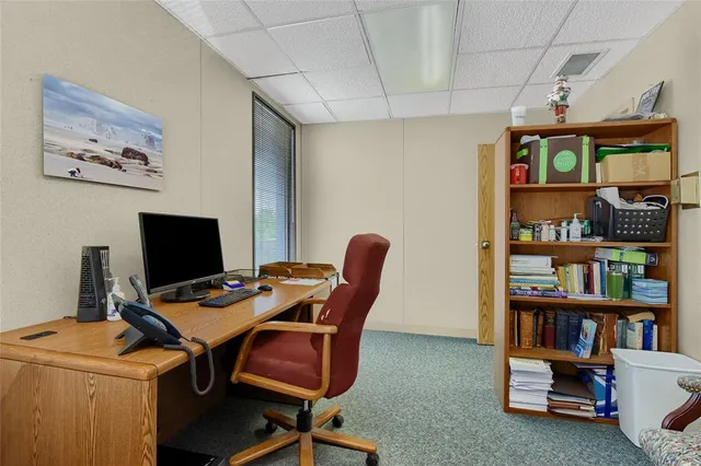 a work room with furniture and book shelf