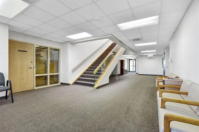a view of a livingroom with furniture and staircase