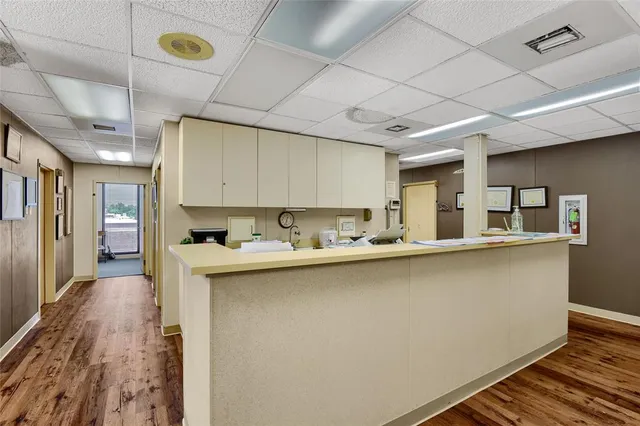 a kitchen with counter top space and wooden floor