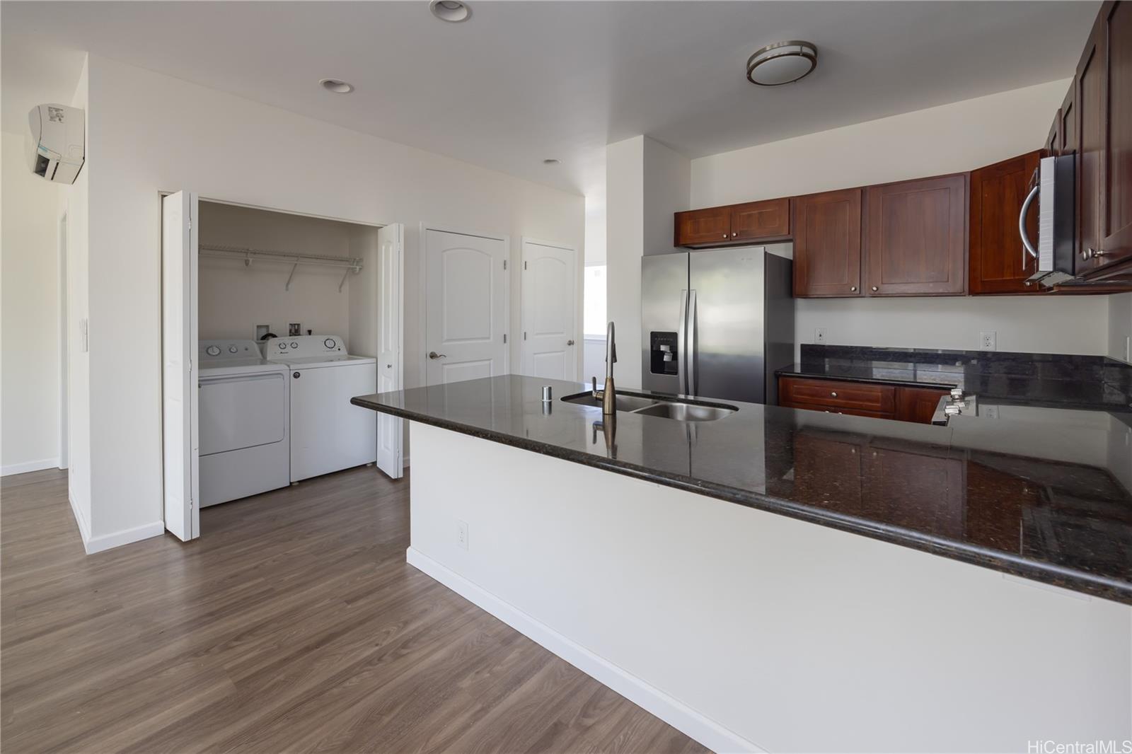 87-176 Maipalaoa Road, Unit Q38 Waianae, HI 96792 - Photo 3 of 18 a large kitchen with stainless steel appliances a sink a refrigerator and wooden floor