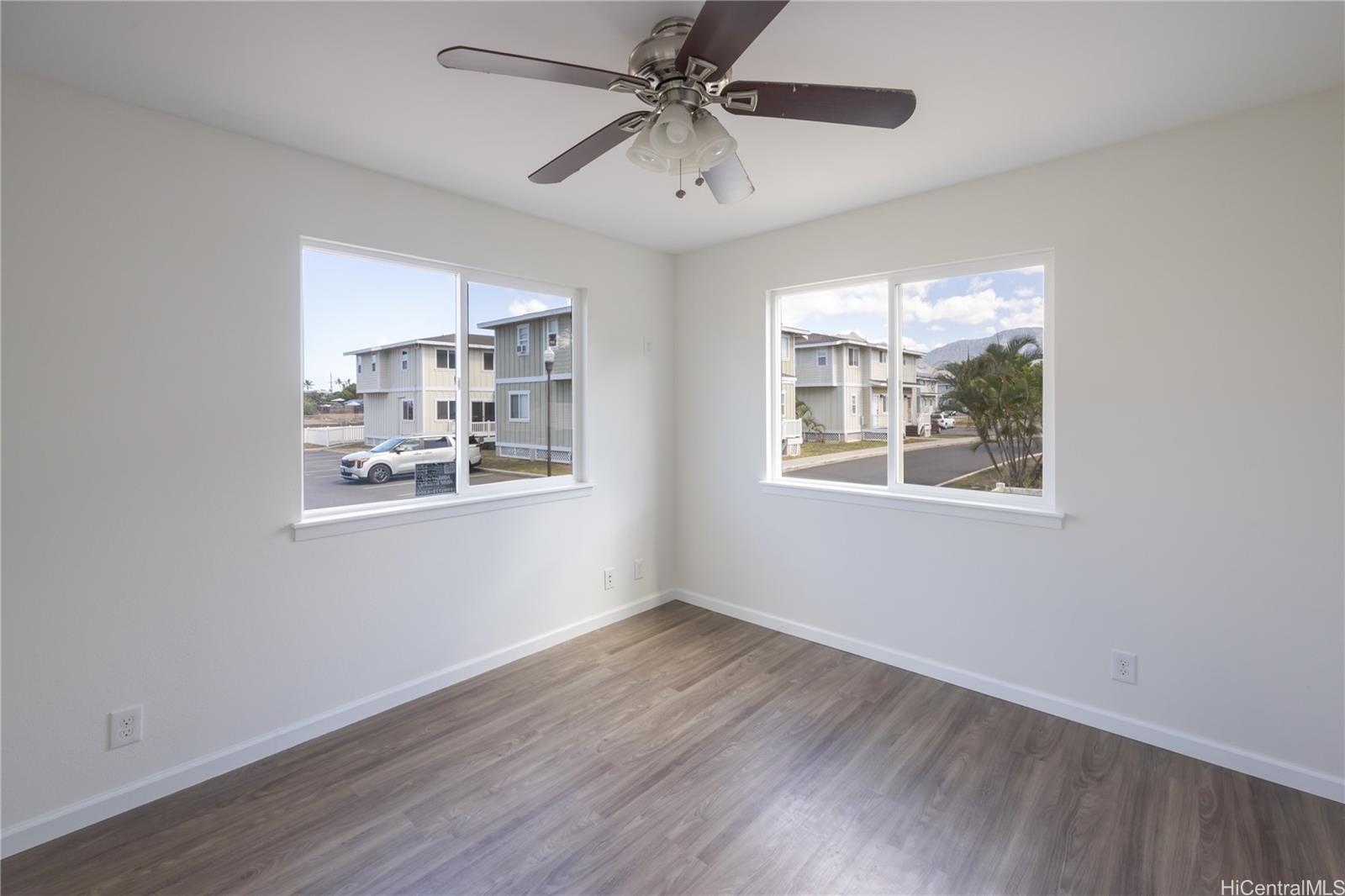 87-176 Maipalaoa Road, Unit Q38 Waianae, HI 96792 - Photo 7 of 18 a view of an empty room with window and wooden floor
