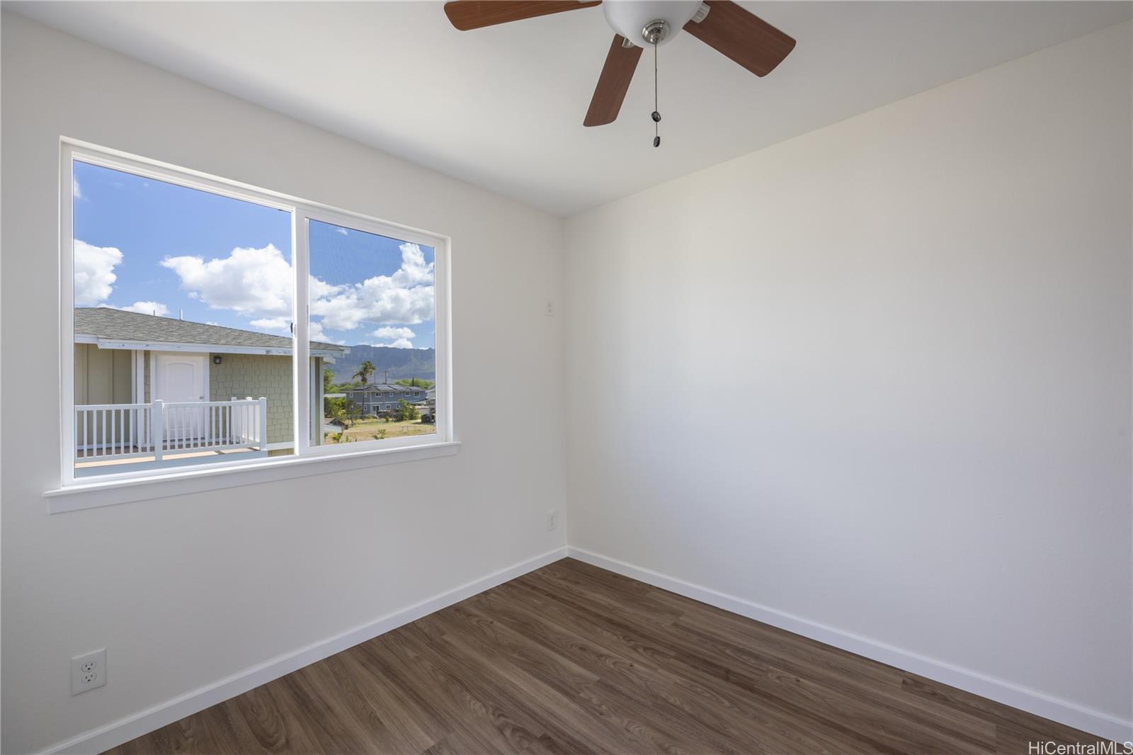 87-176 Maipalaoa Road, Unit Q38 Waianae, HI 96792 - Photo 8 of 18 a view of empty room with wooden floor and fan