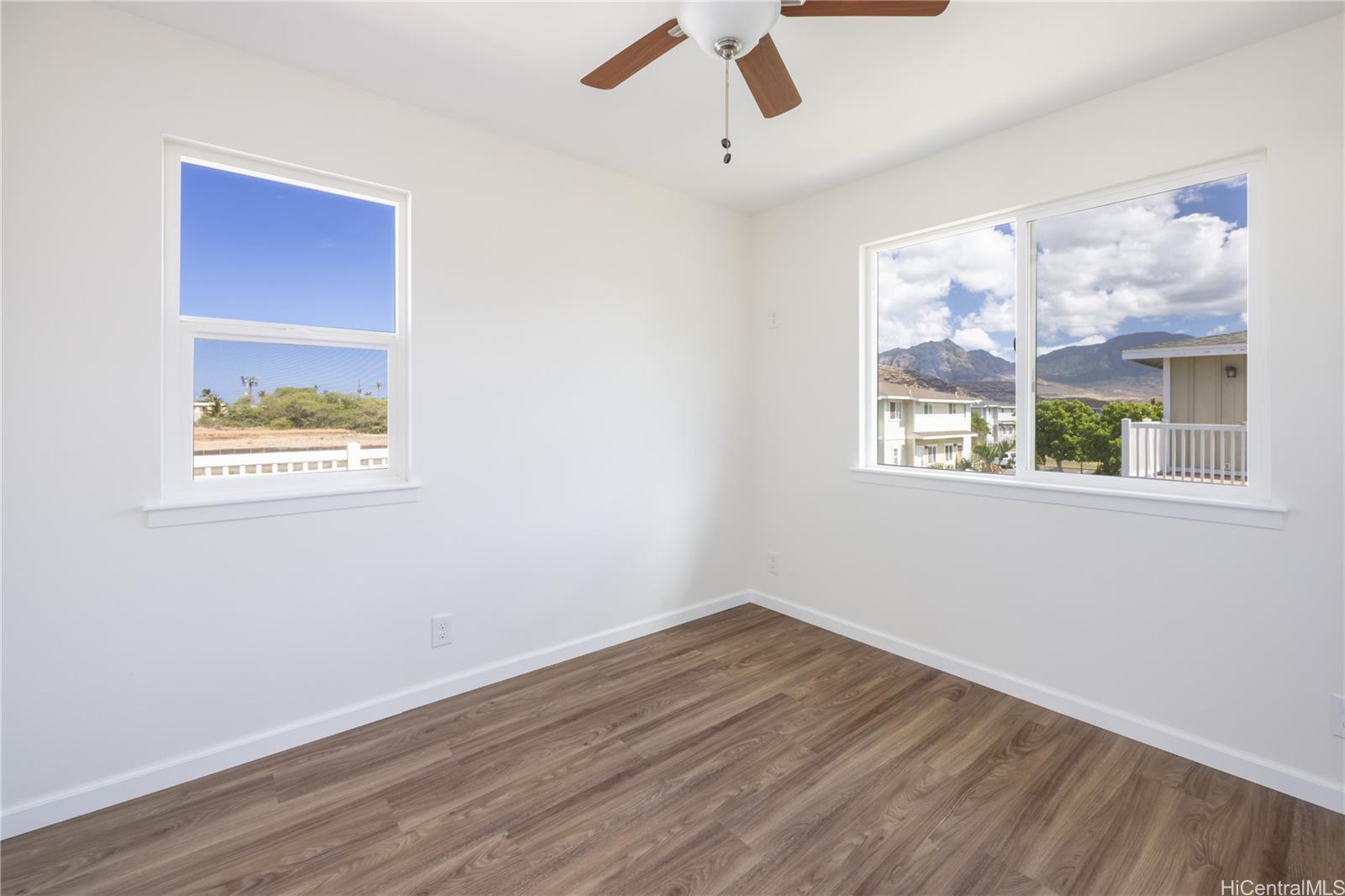 87-176 Maipalaoa Road, Unit Q38 Waianae, HI 96792 - Photo 10 of 18 a view of an empty room with wooden floor and a window