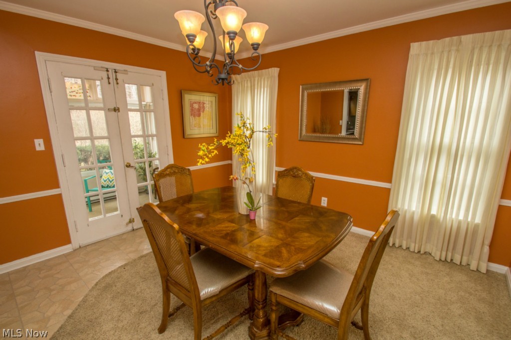 3570 Woodridge Road Cleveland Heights, OH 44121 - Photo 4 of 24 A dining room to seat large gatherings with built in cupboards, chair railing and french doors that open to the sun room.