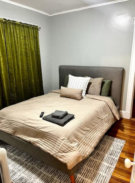 218 Wood Avenue, Unit 1 Boston, MA 02136 - Photo 3 of 11 a large bed sitting in a bedroom next to a wooden cabinet