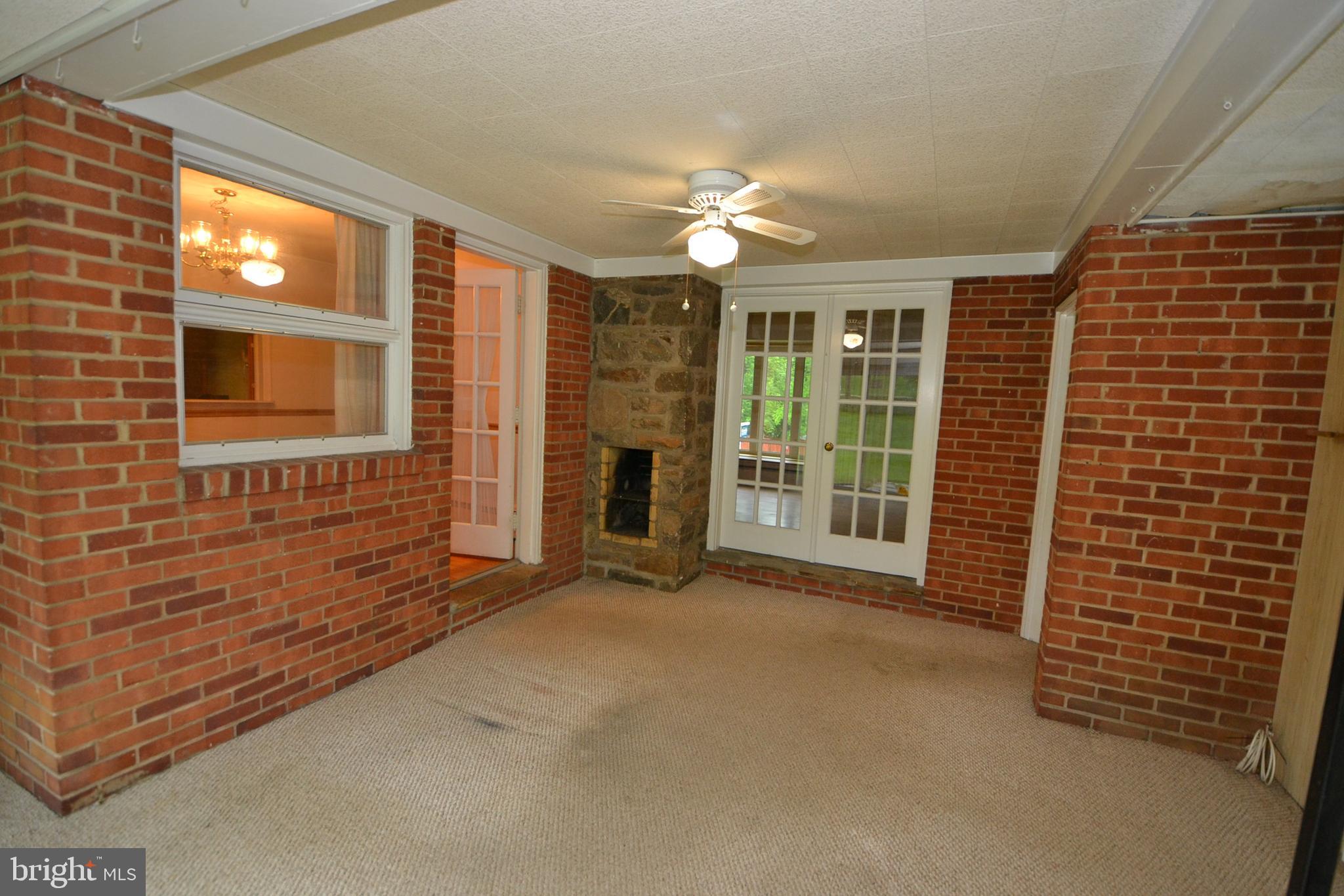 6106 Rusk Avenue Baltimore, MD 21209 - Photo 9 of 42 Sunroom with built-in stone barbecue