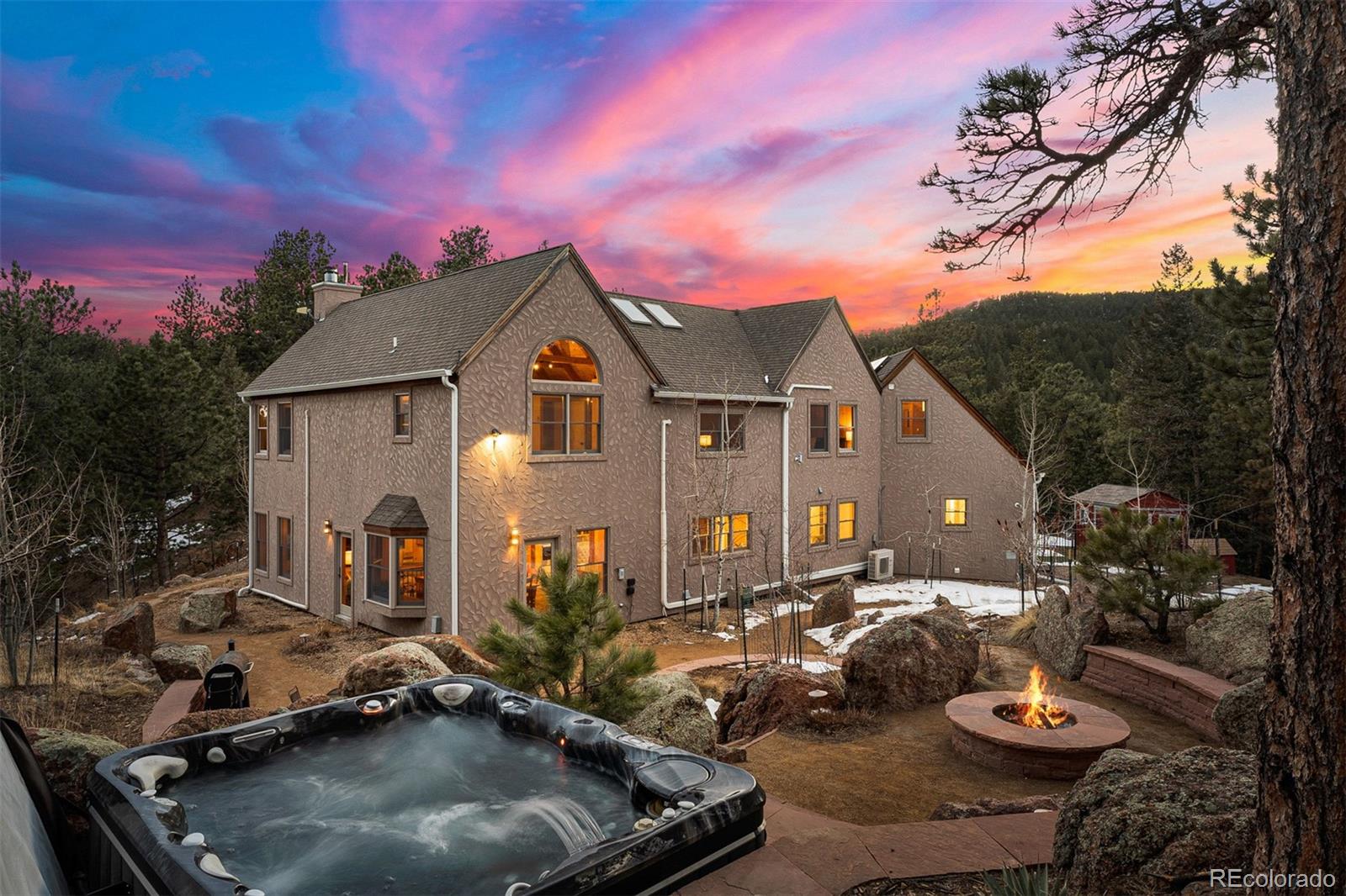 a view of a house with backyard tub and fire pit