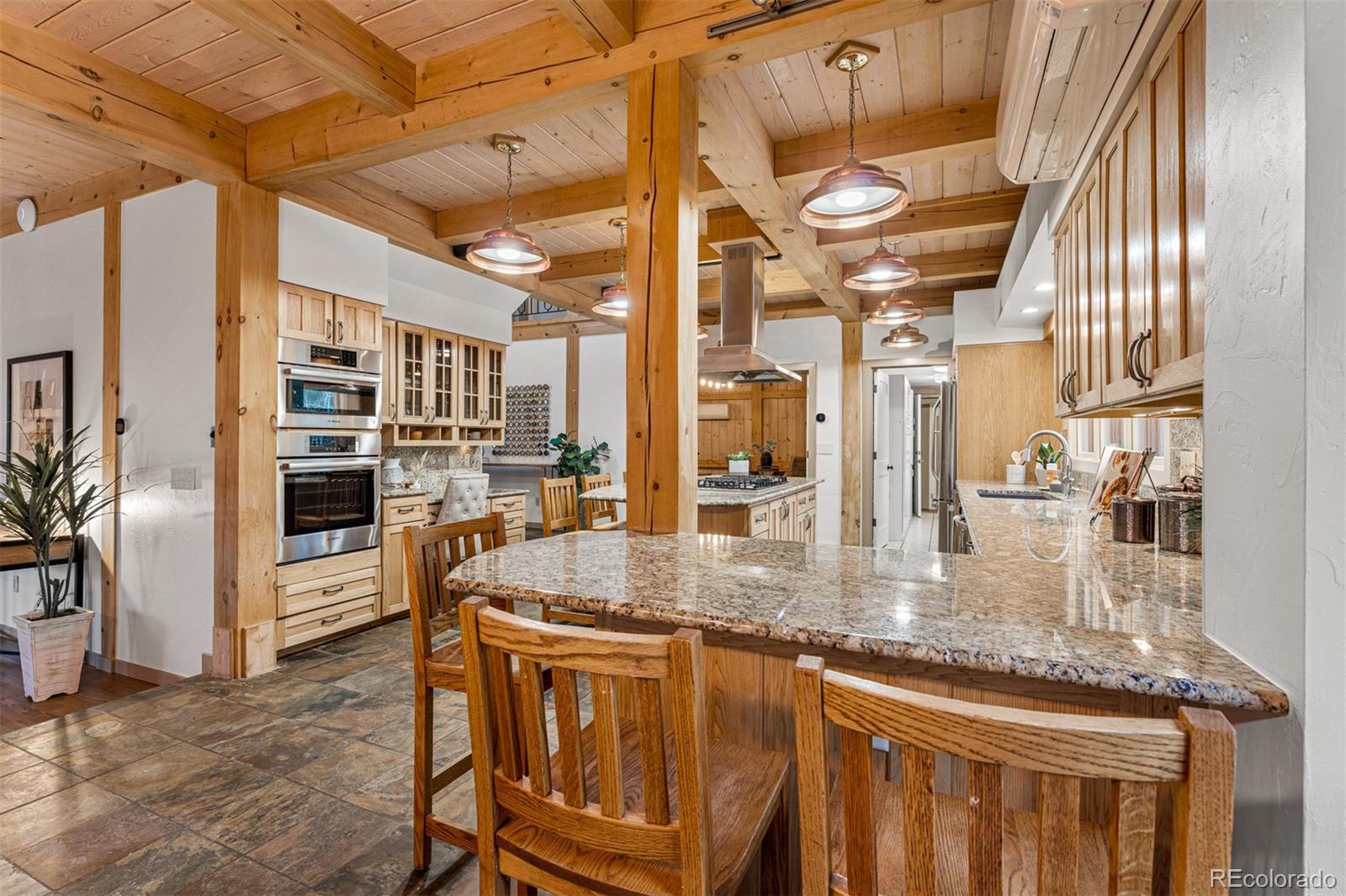 1057 Reed Ranch Road Boulder, CO 80302 - Photo 14 of 40 a kitchen with stainless steel appliances granite countertop a sink and cabinets
