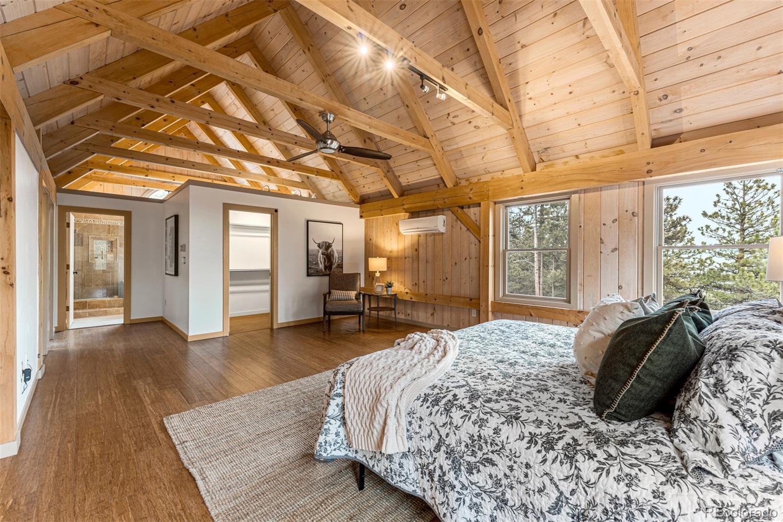 1057 Reed Ranch Road Boulder, CO 80302 - Photo 26 of 40 a spacious bedroom with a bed and wooden floor