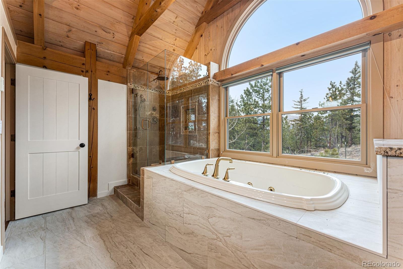 1057 Reed Ranch Road Boulder, CO 80302 - Photo 28 of 40 a bathroom with a tub and shower