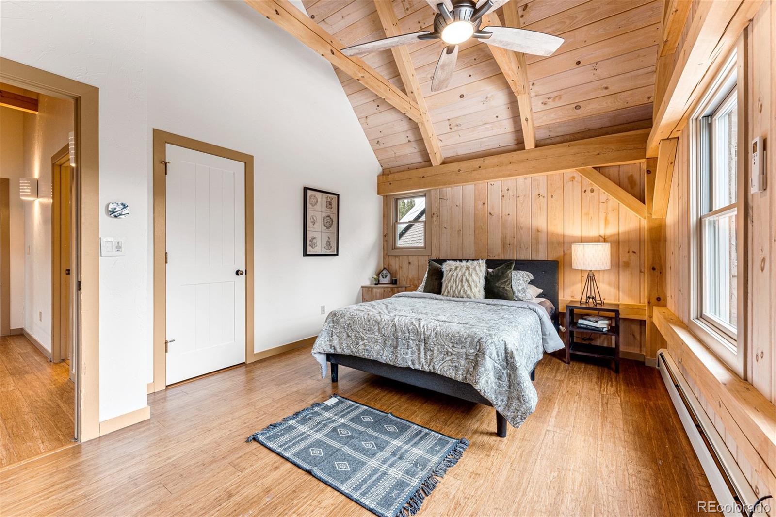 1057 Reed Ranch Road Boulder, CO 80302 - Photo 29 of 40 a bedroom with a bed and wooden floor