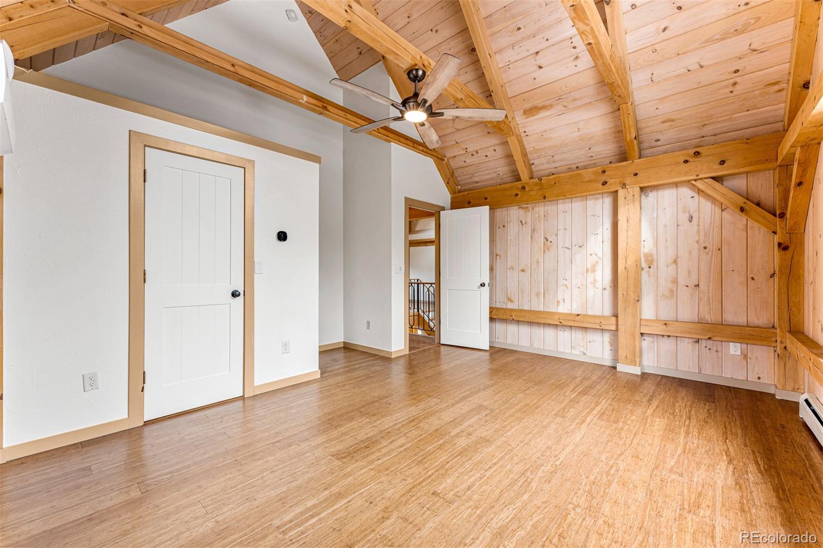 1057 Reed Ranch Road Boulder, CO 80302 - Photo 31 of 40 a view of an empty room with wooden floor