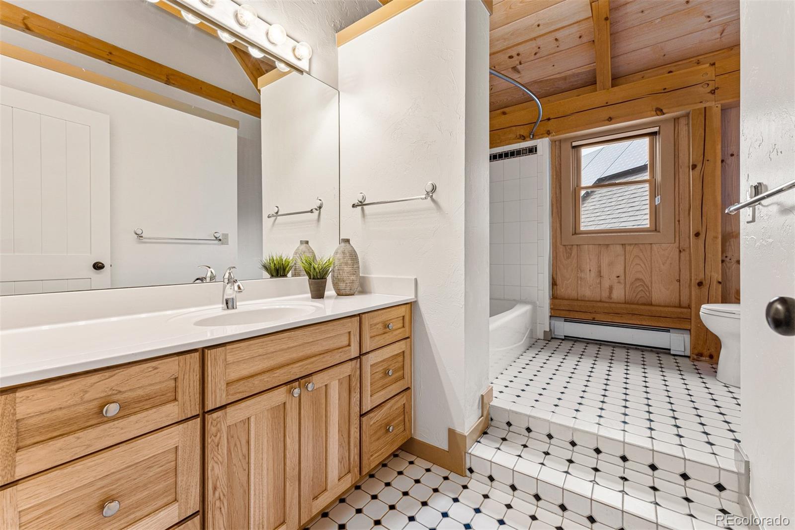 1057 Reed Ranch Road Boulder, CO 80302 - Photo 32 of 40 a bathroom with a sink a toilet and a shower