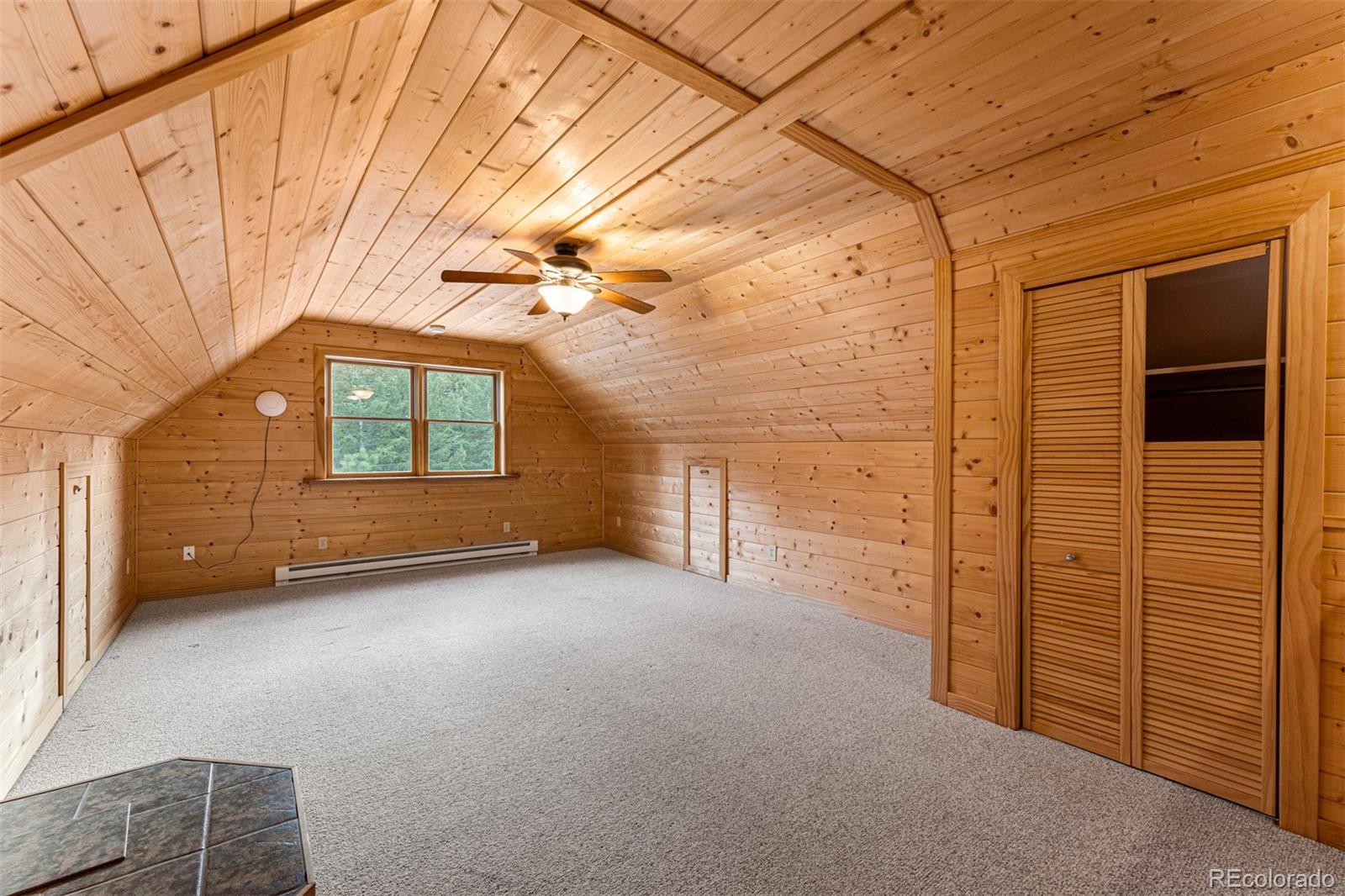 1057 Reed Ranch Road Boulder, CO 80302 - Photo 33 of 40 a view of a room with wooden walls and windows