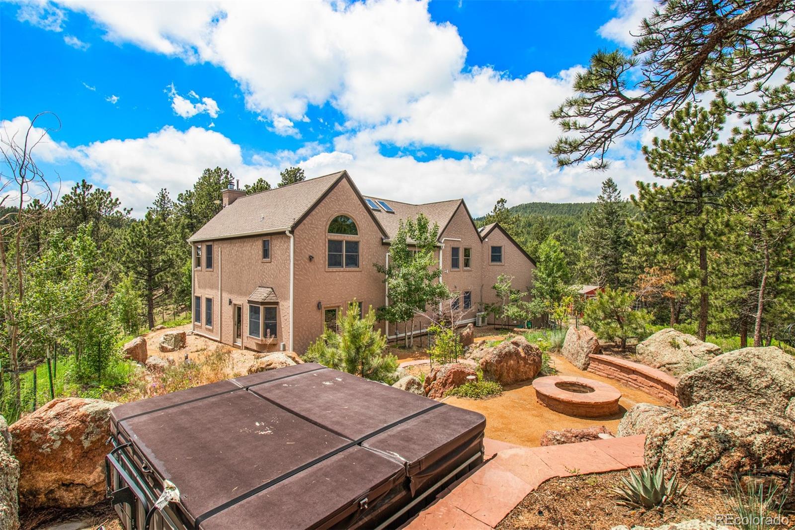 1057 Reed Ranch Road Boulder, CO 80302 - Photo 36 of 40 a view of a patio with table and chairs and potted plants