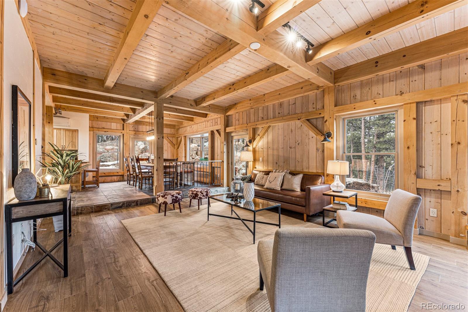 1057 Reed Ranch Road Boulder, CO 80302 - Photo 10 of 40 a living room with furniture and a chandelier