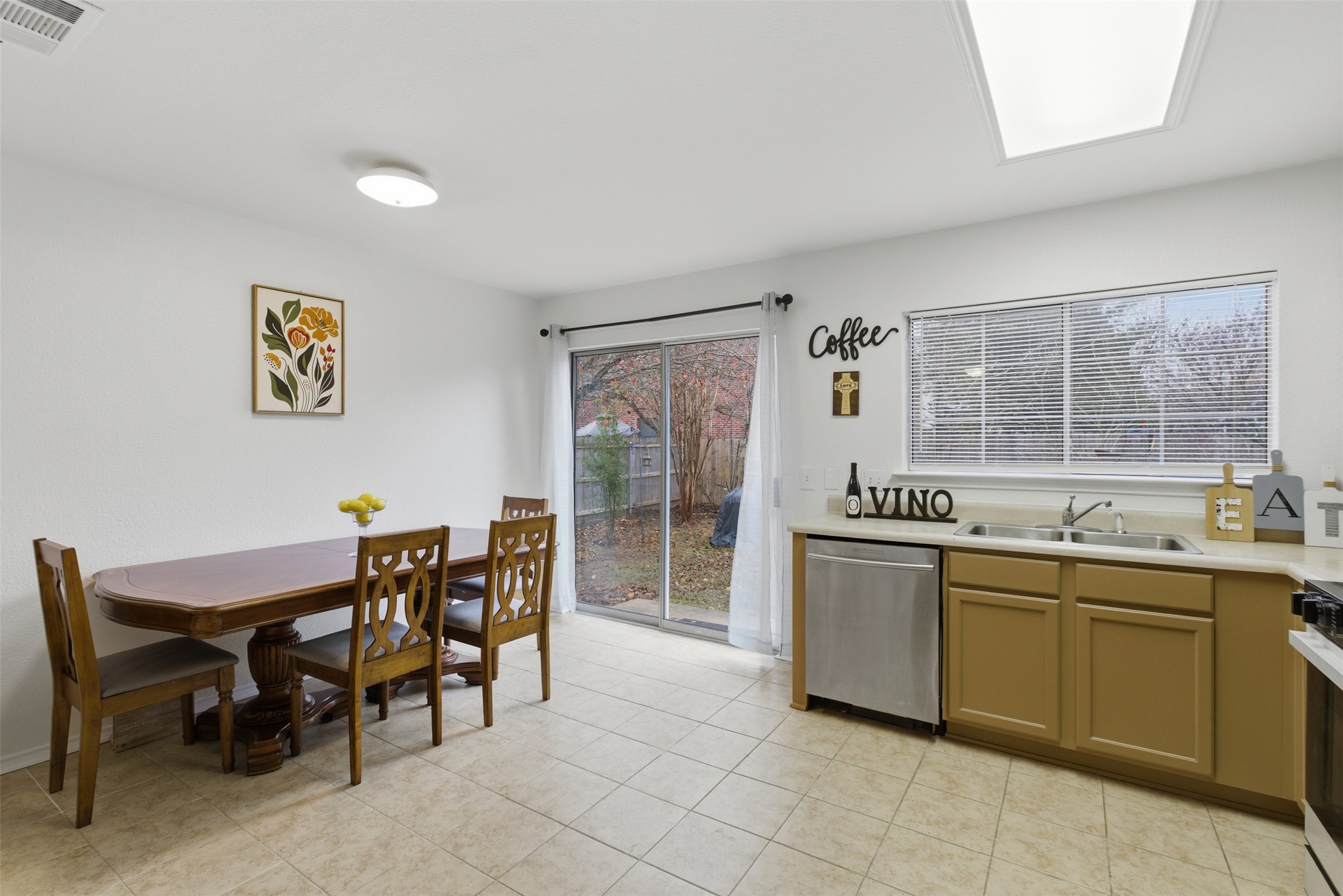7536 Marble Ridge Drive Austin, TX 78747 - Photo 17 of 30 Kitchen featuring light countertops, appliances with stainless steel finishes, and a skylight