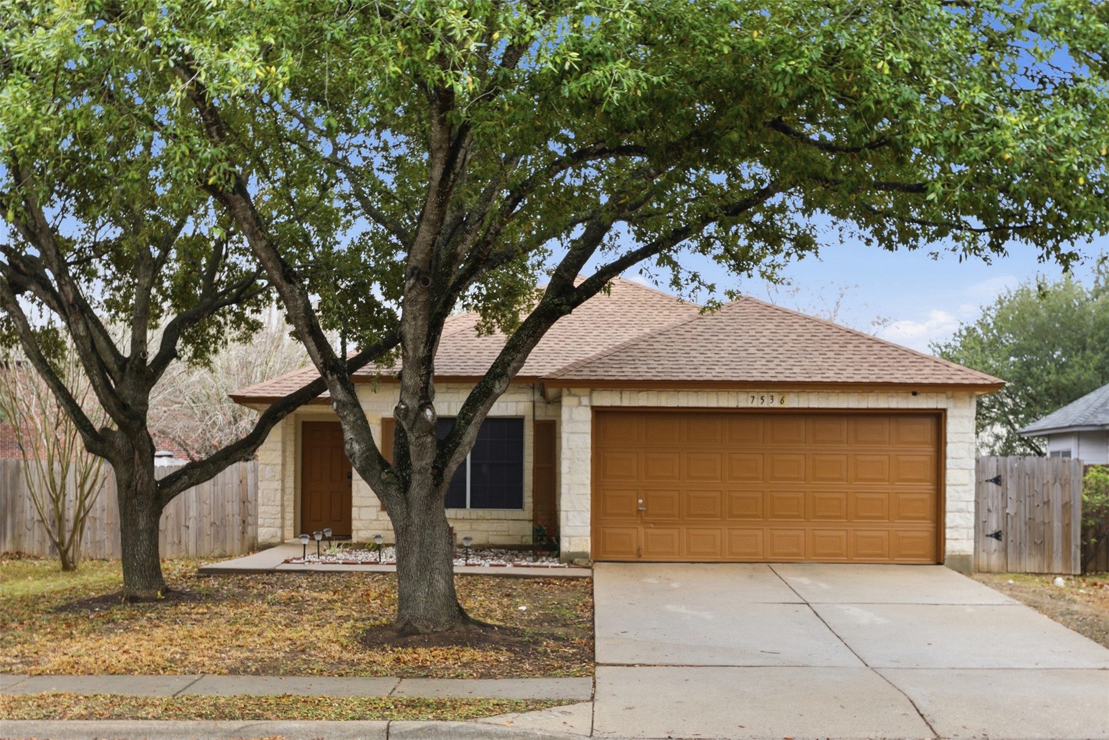 7536 Marble Ridge Drive Austin, TX 78747 - Photo 2 of 30 Ranch-style house featuring a shingled roof, concrete driveway, and an attached garage