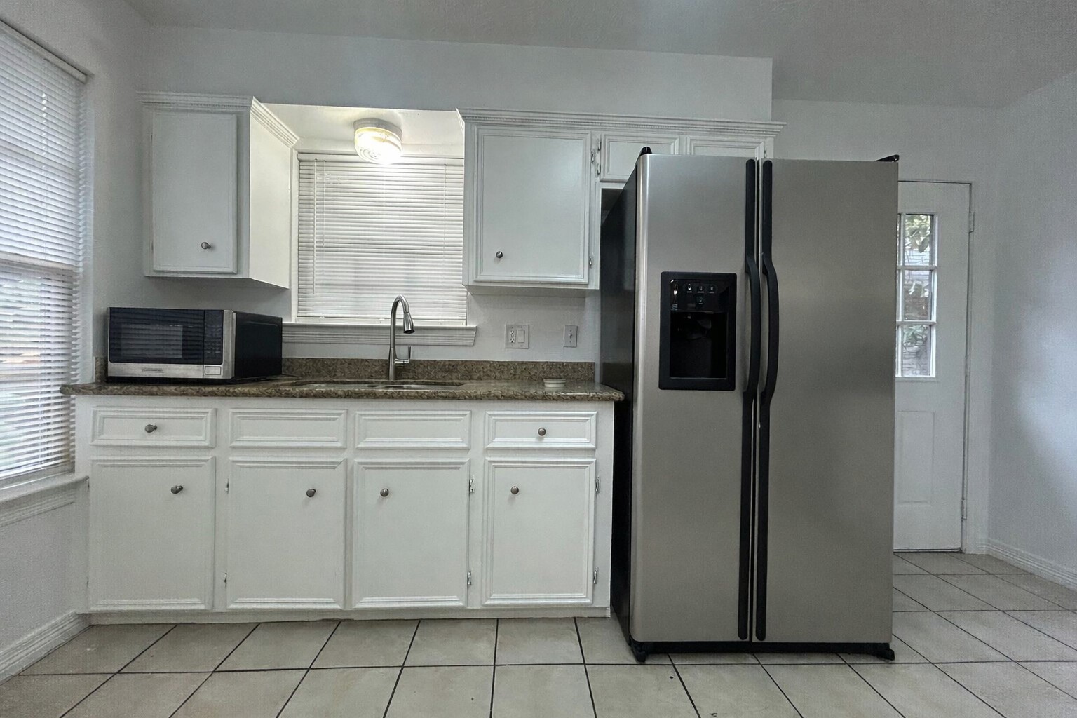 1614 Common Street Houston, TX 77009 - Photo 2 of 13 a kitchen with stainless steel appliances granite countertop a refrigerator and a stove