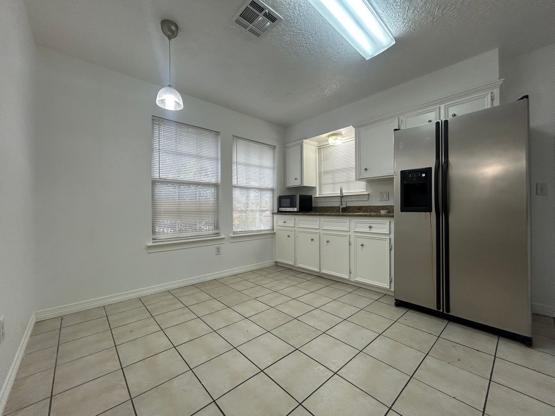 1614 Common Street Houston, TX 77009 - Photo 3 of 13 a kitchen with a sink a refrigerator and window